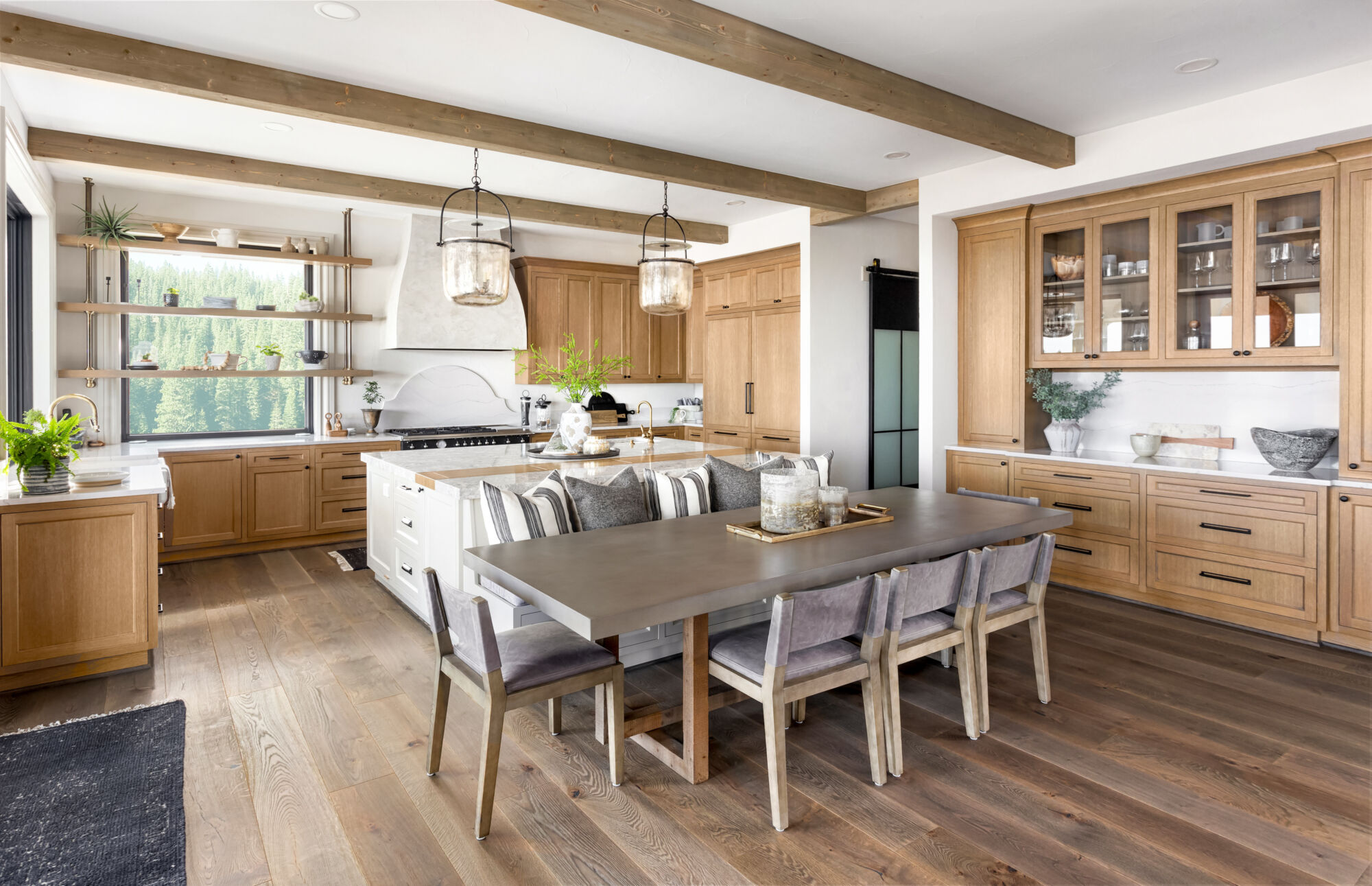 Traditional kitchen in new luxury home with hardwood floors, wood Traditional kitchen in new luxury home with hardwood floors, wood beams, large island and quartz counters
