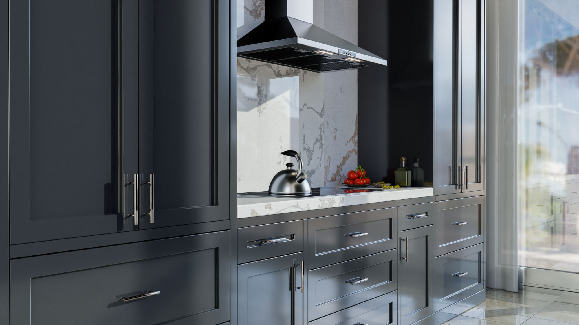 Inset style kitchen cabinets. A stainless steel kettle sits on a stovetop next to a bowl of tomatoes, with glossy dark grey cabinets and a marble backsplash in the background.