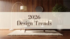 A warm, inviting living room featuring a dark brown composite panel accent wall, a curated bookshelf in warm wood tone composite panels, a cozy fireplace along the back wall, and a central coffee table paired with orange-framed artwork.